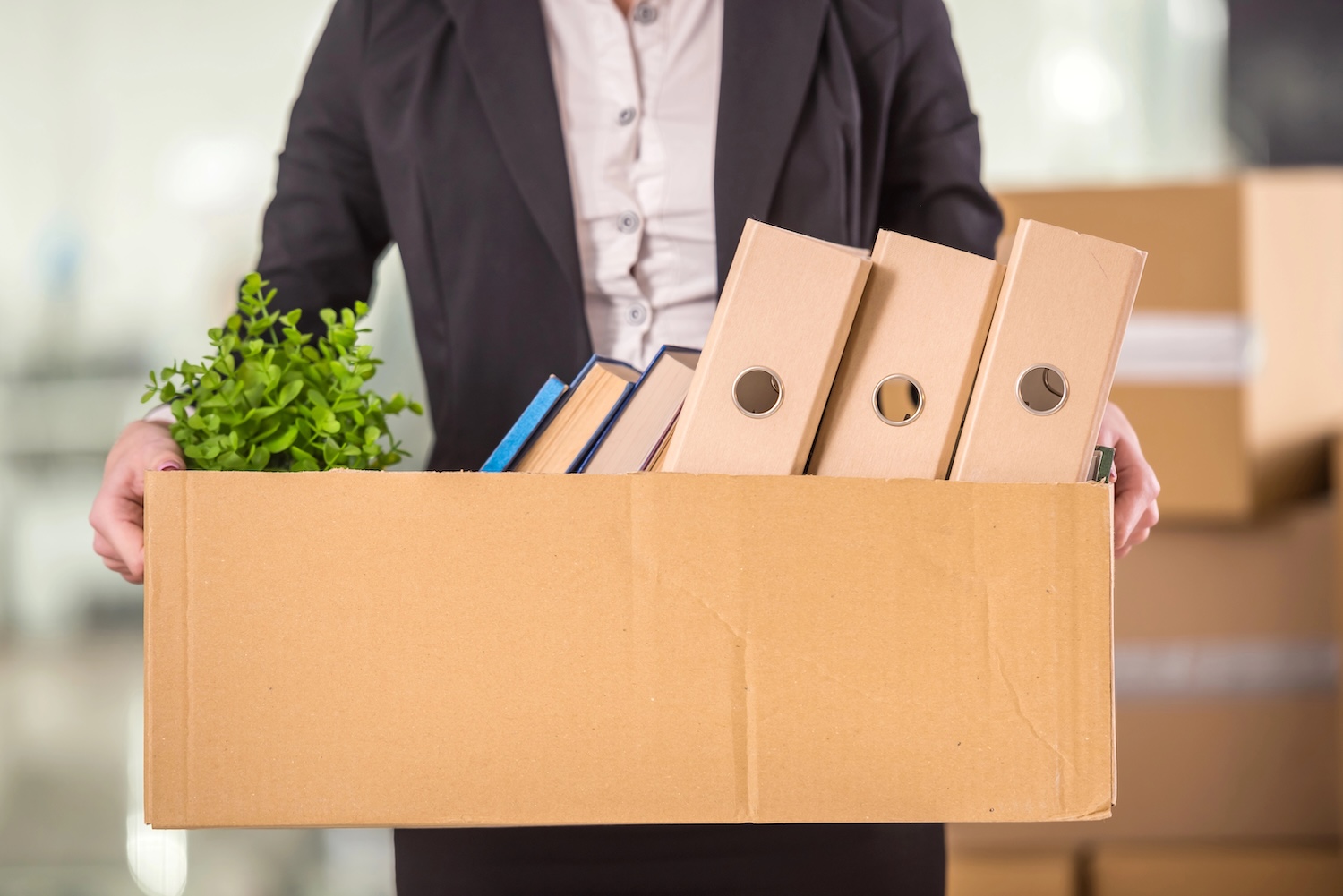 person laid off from job carrying box