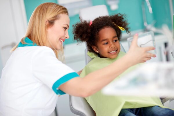 Dental assistant with young patient