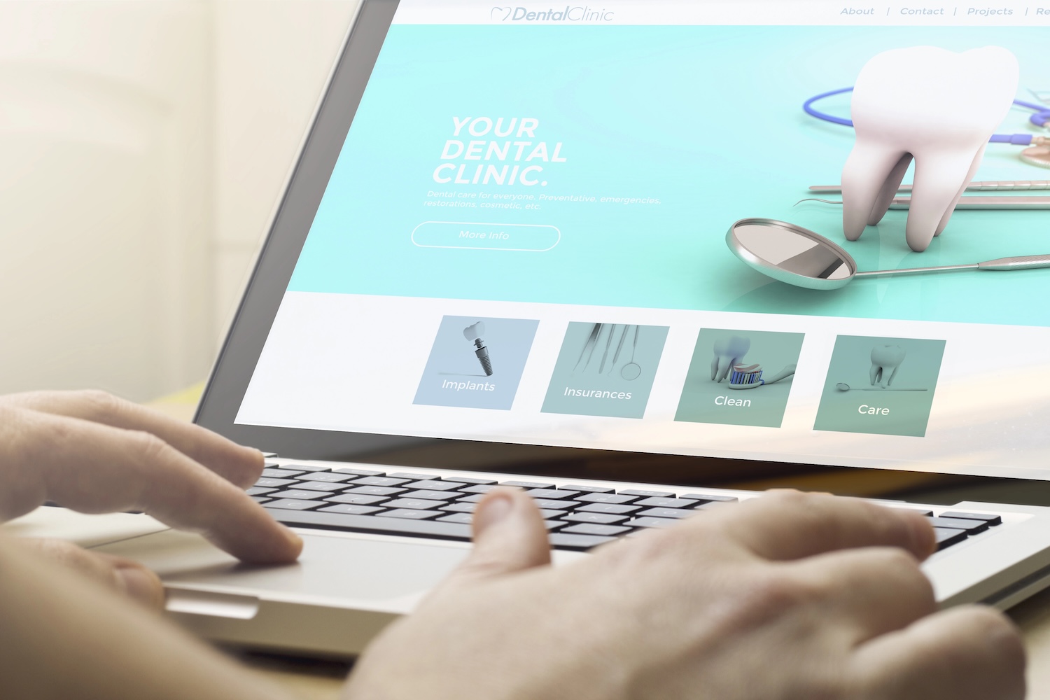 online business concept: man using a laptop with dental concept on the screen. Screen graphics are made up.
