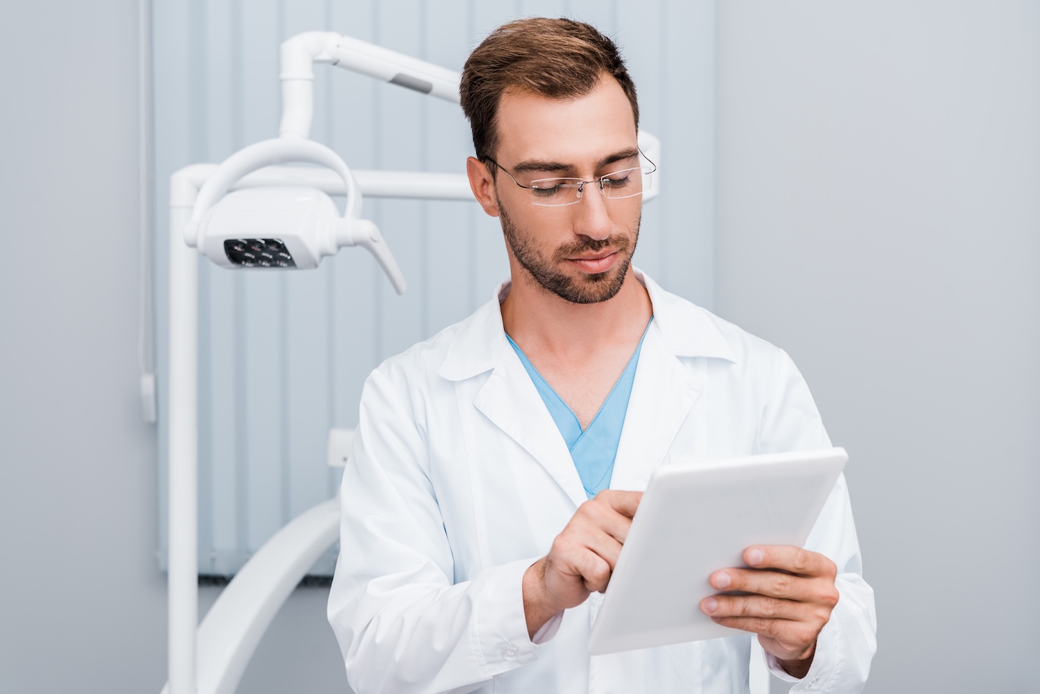 dentist looking at social media on tablet