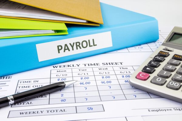 payroll notebook with calculator
