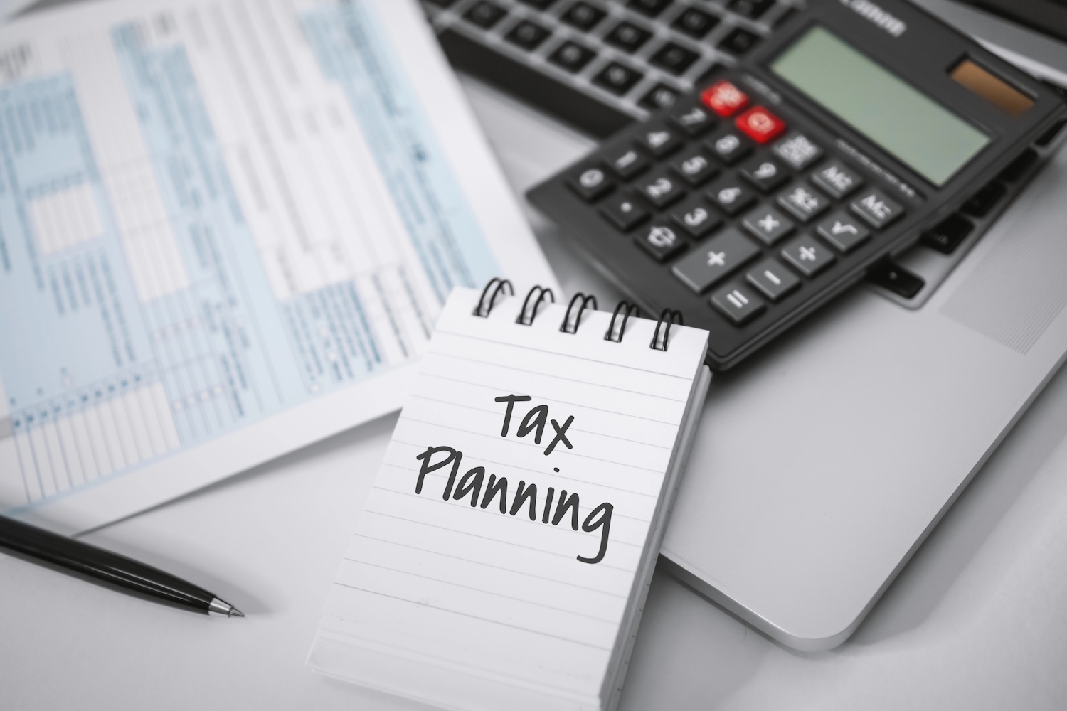 Tax Planning. Notebook, Calculator and Income Tax Form.