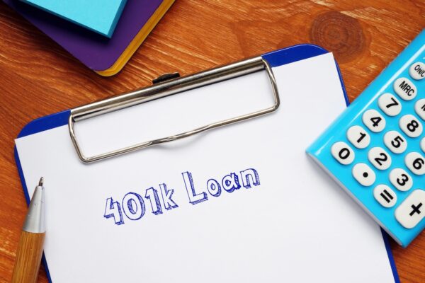 401k Loan with sign on the piece of paper.