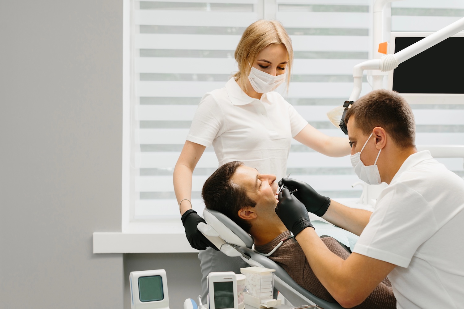 Dentist with an assistant work in a dental clinic.