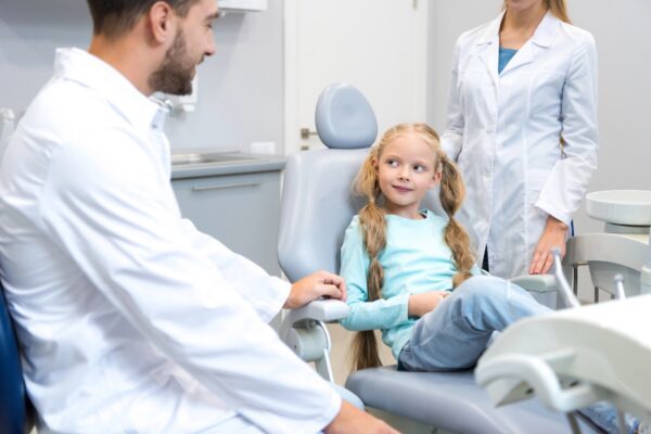 New dentist with child patient and hygienist