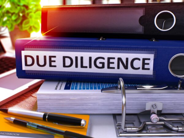 desk with notebook labeled Due Diligence