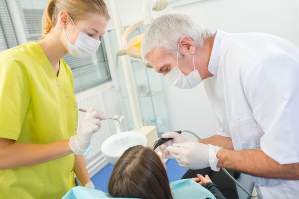 Busy dentist with a patient
