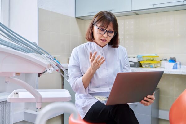 Dentist working on a computer in her office